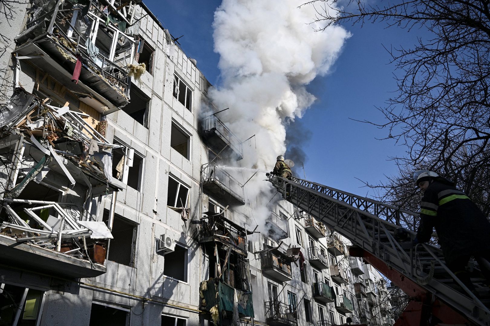 Firefighters work on a fire on a building after bombings on the eastern Ukraine town of Chuguiv. February 24, 2022