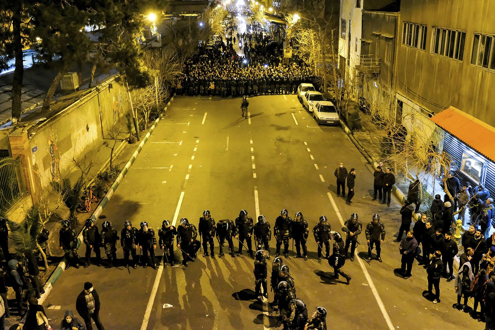 Iranian police officers take position while protesters gather in Tehran, Iran, to remember victims of a Ukrainian airplane shot down by an Iranian missile. 11 January 2020