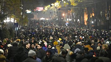 Demonstrators rally outside the parliament to protest against the government's decision to suspend negotiations on joining the European Union in Tbilisi, Georgia, Sunday, Dec.