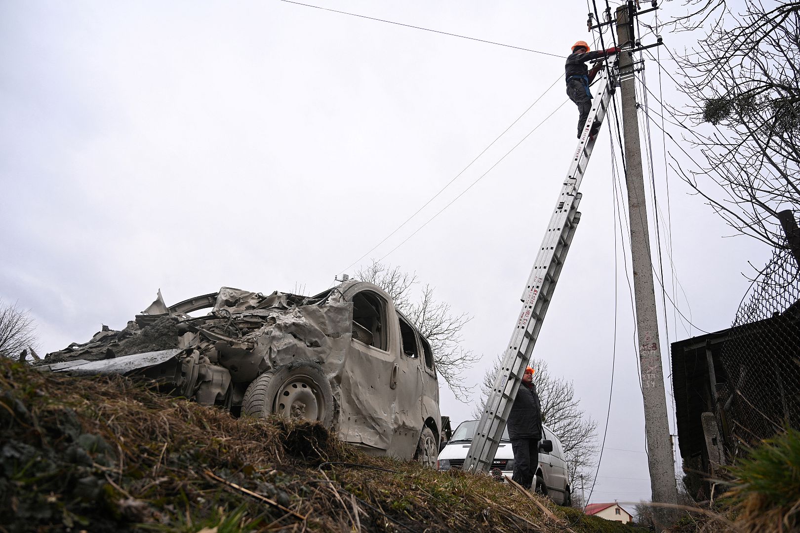 A worker repairs a power line following a Russian strike in the village of Velyka Vilshanytsia, some 50km from Lviv. March 9, 2023