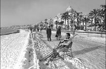 A man takes off his skis to rest at the Promenade des Anglais after  rare heavy snowfall in Nice, France. January 8, 1985