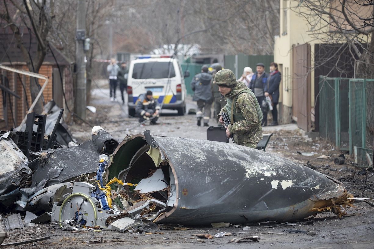 A Ukrainian Army soldier inspects fragments of a downed aircraft in Kyiv, Ukraine. February 25, 2022