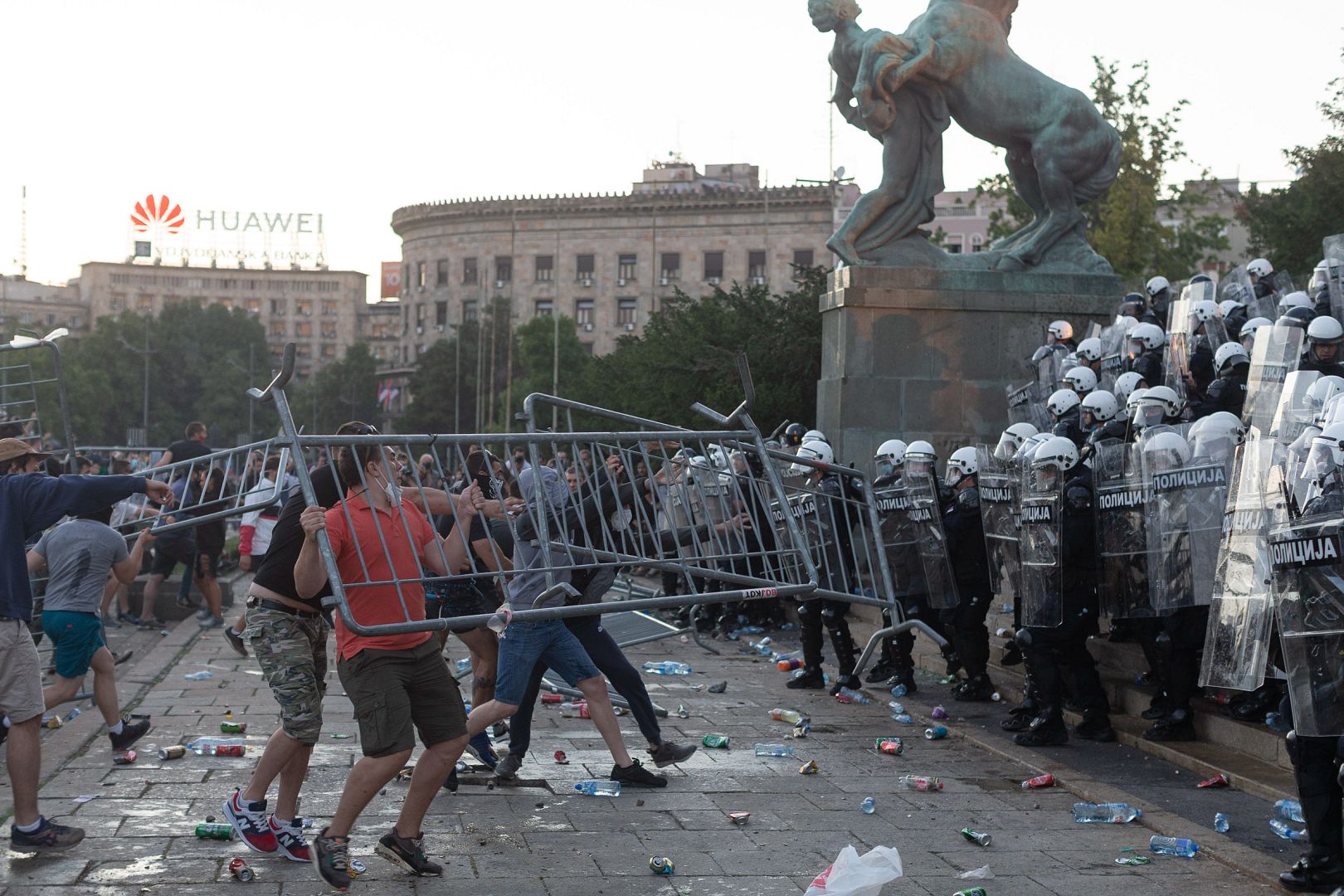 Protesters throw barricades at riot police in Belgrade, Serbia. July 8, 2020