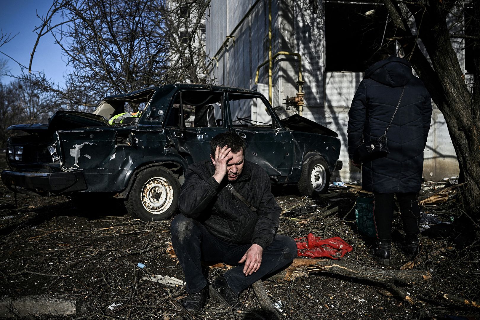  A man sits outside his destroyed building after bombings on the eastern Ukraine town of Chuguiv as Russian armed forces invaded Ukraine from several directions. February 24, 