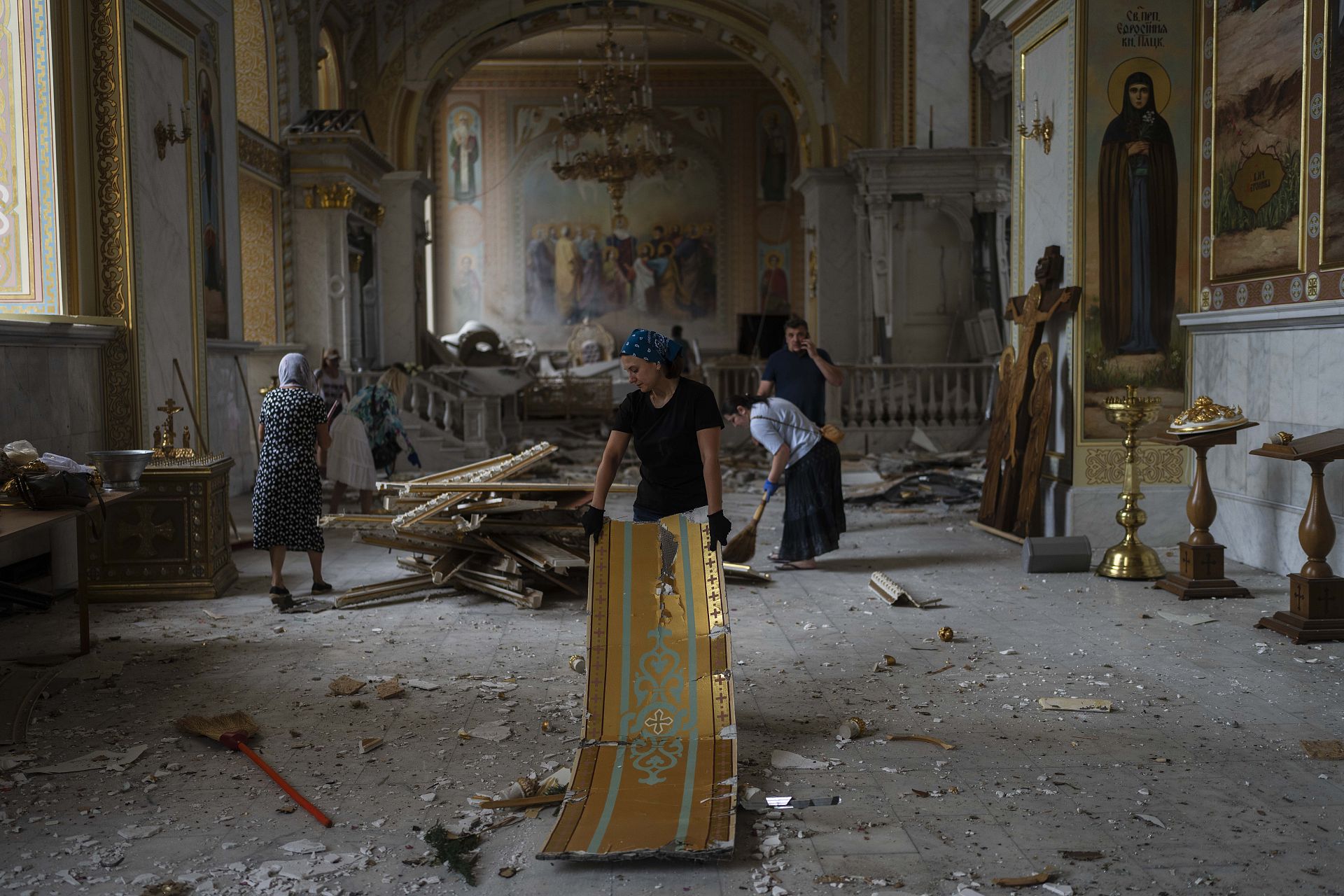 Residents clear debris inside the Odesa Transfiguration Cathedral after Russian missile attacks devastated the Ukrainian landmark. Odesa, Ukraine. July 23, 2023. 
