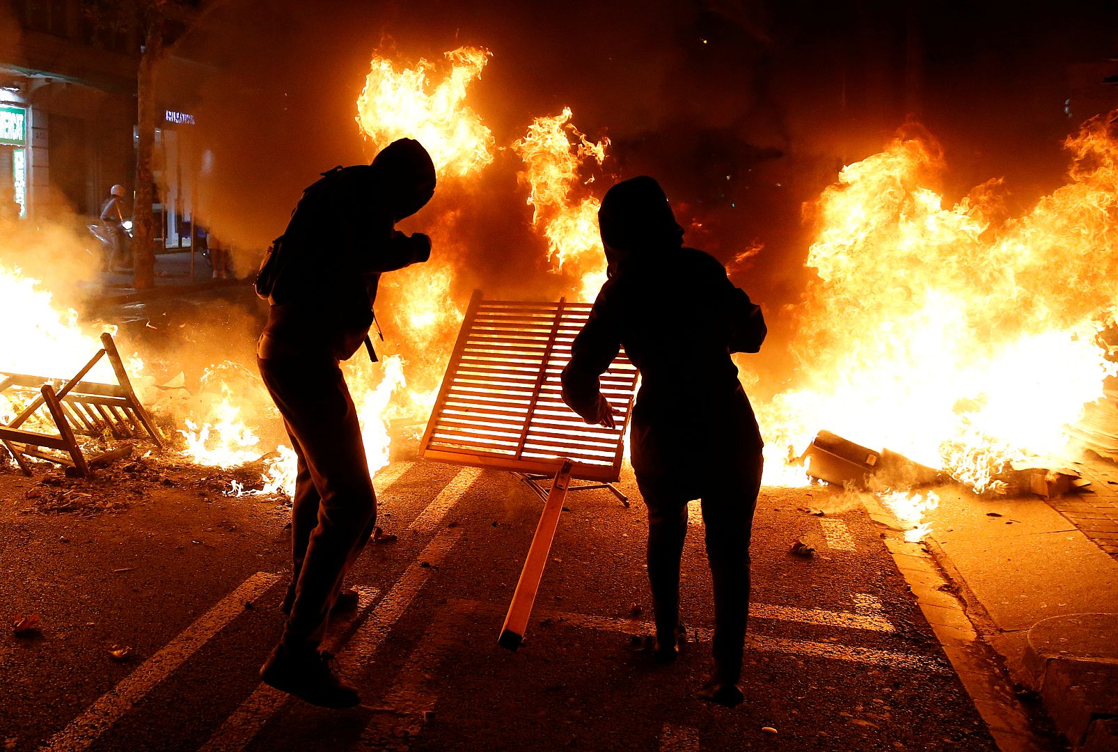 Manifestantes lanzan objetos al fuego en Barcelona, España, el 15 de octubre de 2019.