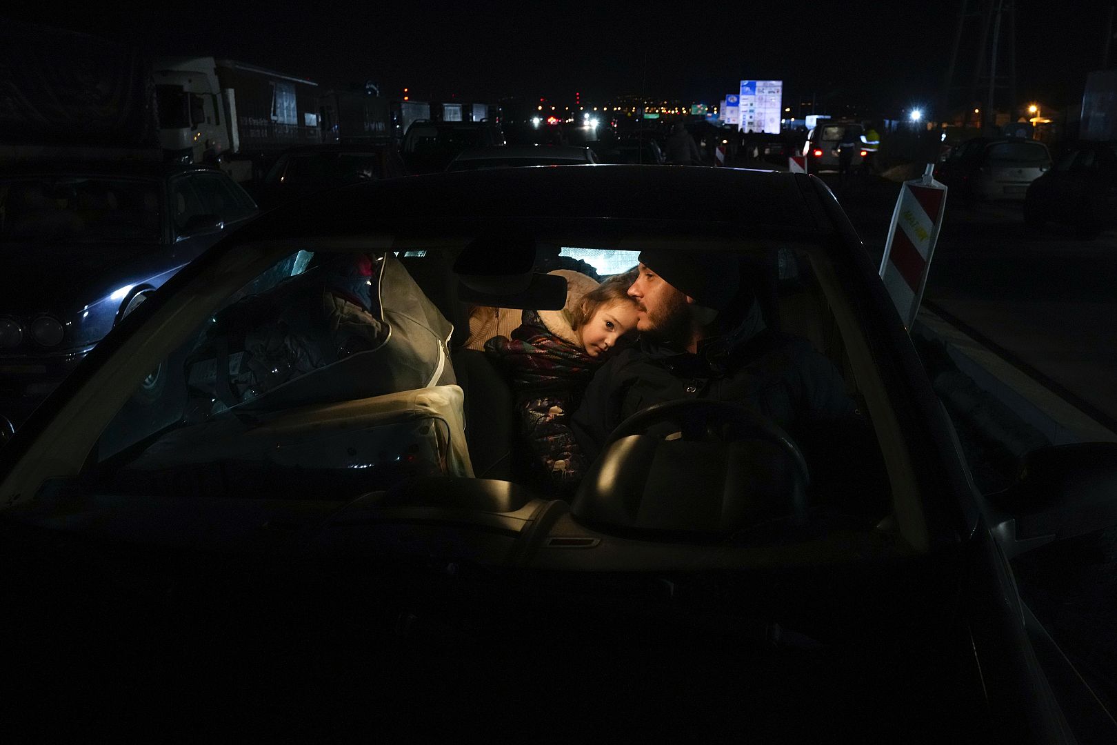 People fleeing the conflict from neighboring Ukraine meet with members of their family at the border crossing in Medyka, southeastern Poland. February 25, 2022