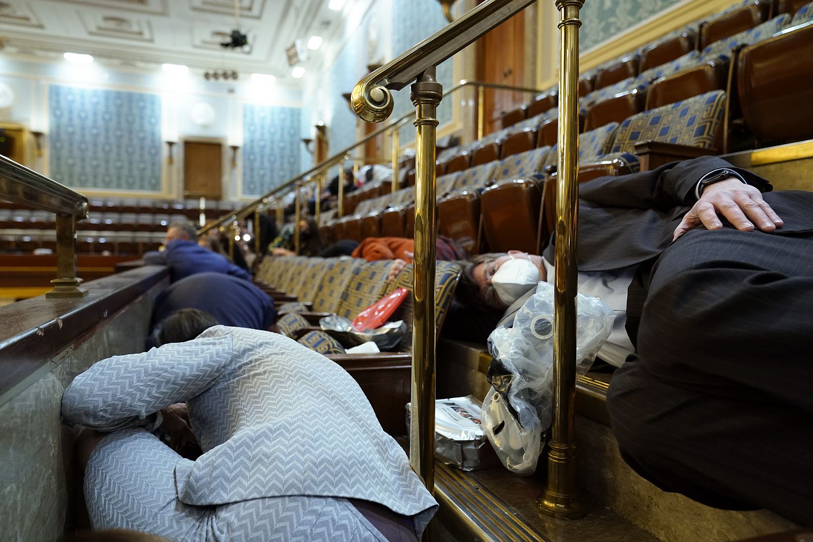 People shelter in the House gallery as protesters were about to break into the House Chamber at the U.S. Capitol, Washington, USA. January 6, 2021