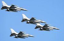 U.S.-made F-16 fighter jets fly in the sky over Poland's capital as they take part in a massive military parade to celebrate the Polish Army Day, 15/08/2023.