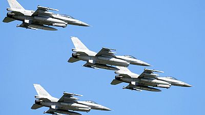 U.S.-made F-16 fighter jets fly in the sky over Poland's capital as they take part in a massive military parade to celebrate the Polish Army Day, 15/08/2023.