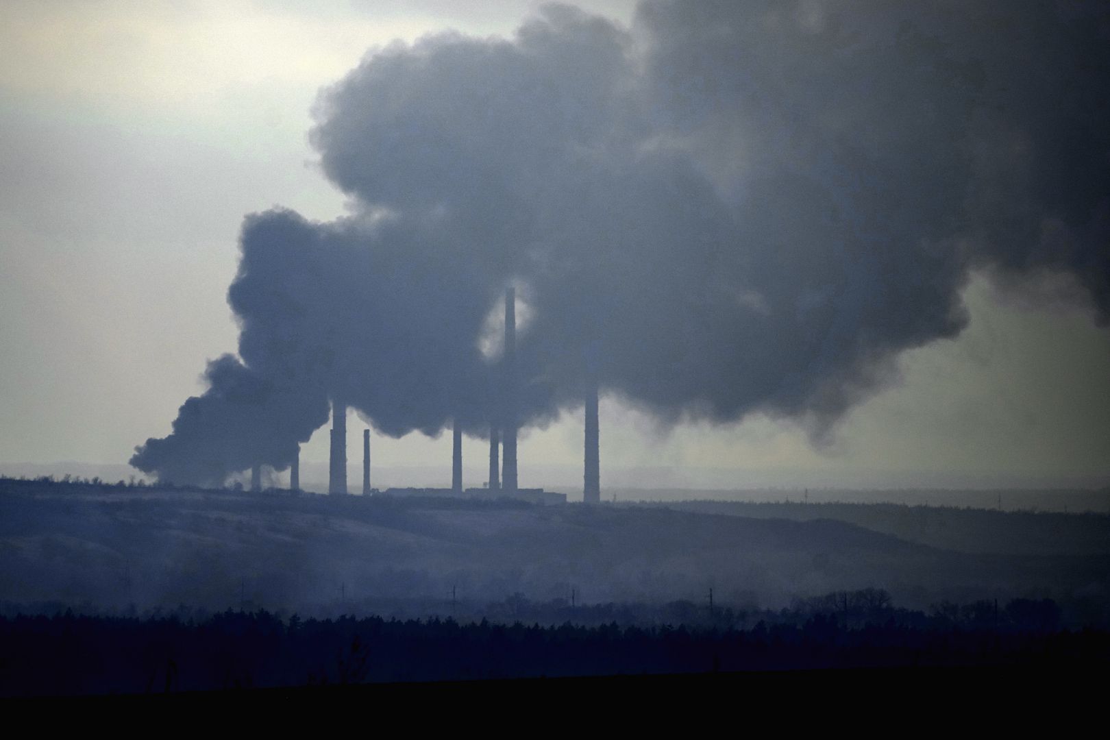 Smoke billows from a power and heating plant after it was shelled in Shchastya, in the Luhansk region, eastern Ukraine. February 22, 2022