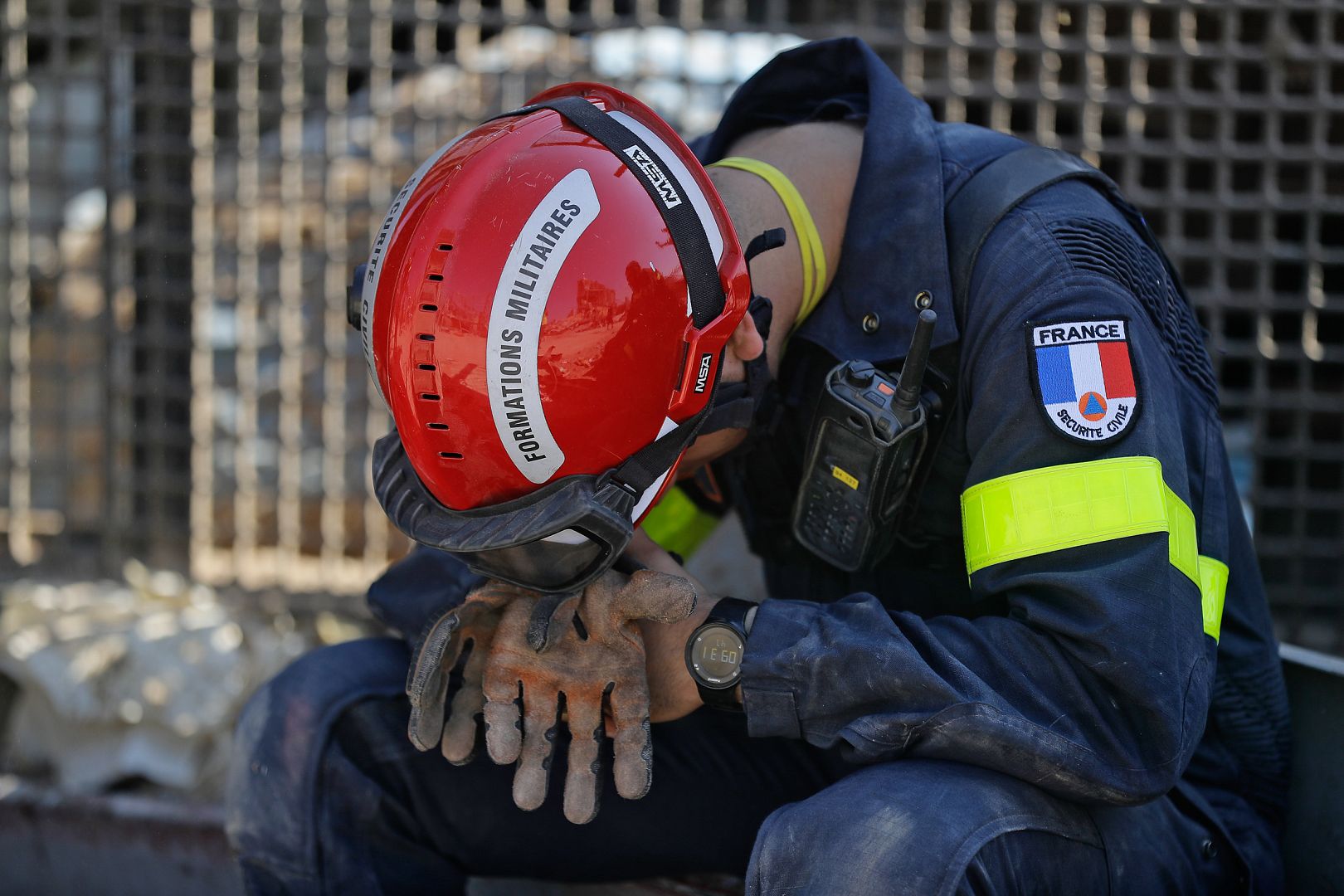 A French rescue worker rests during search efforts in the devastated Beirut port on August 7, 2020, three days after a massive blast shook the Lebanese capital