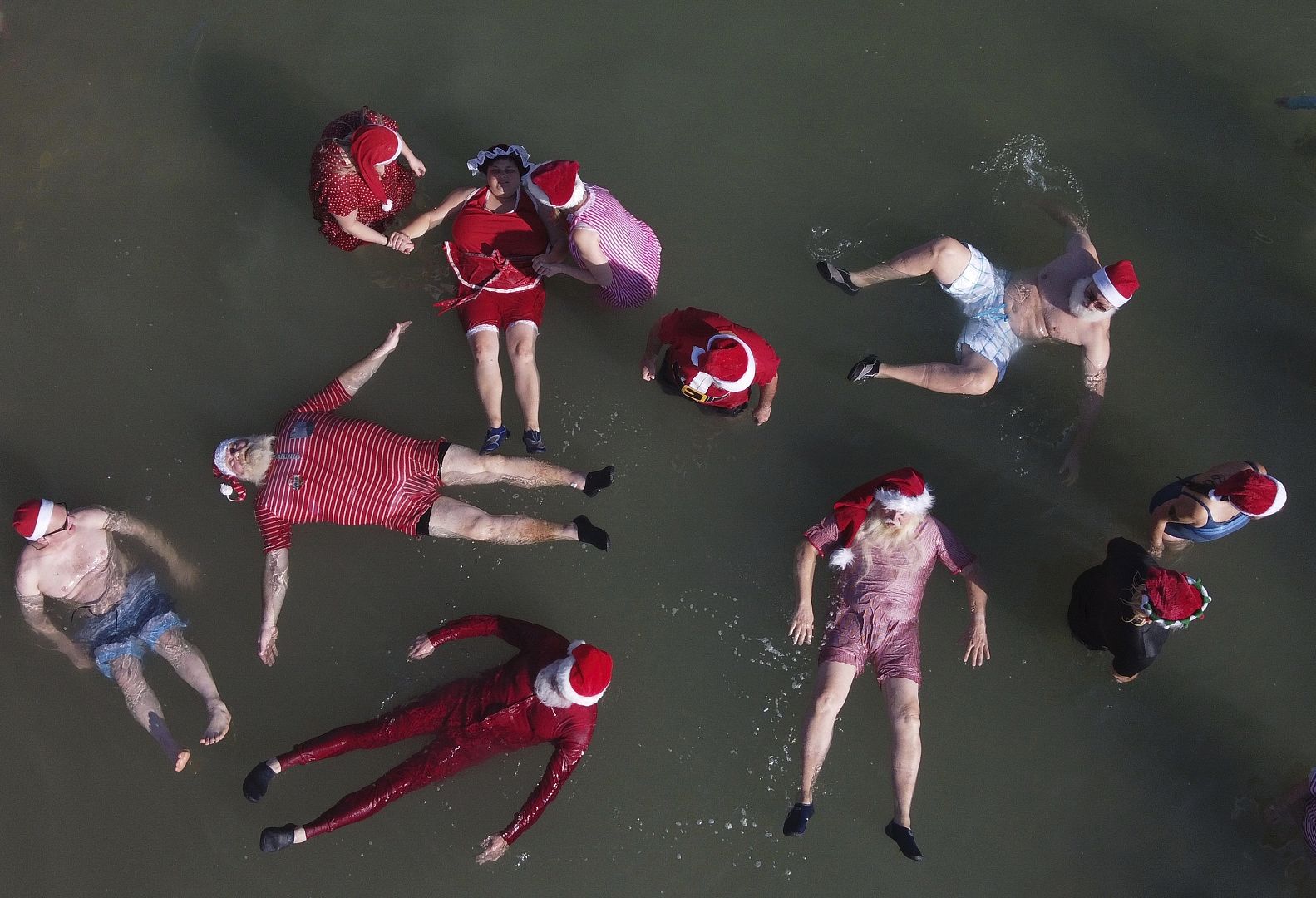 Members of a group of trained Santa Clauses from Europe and the USA float in the Dead Sea near the West Bank city of Jericho, 7 January, 2020.