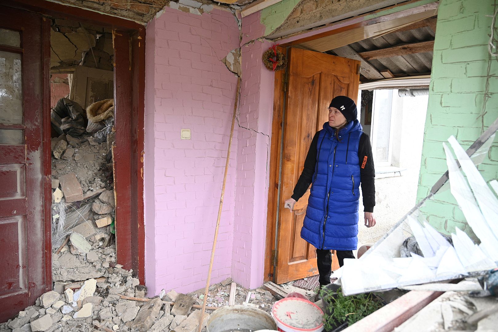 A woman searches the rubble of the destroyed house of her relatives following a Russian strike in the village of Velyka Vilshanytsia, near Lviv, Ukraine. March 9, 2023