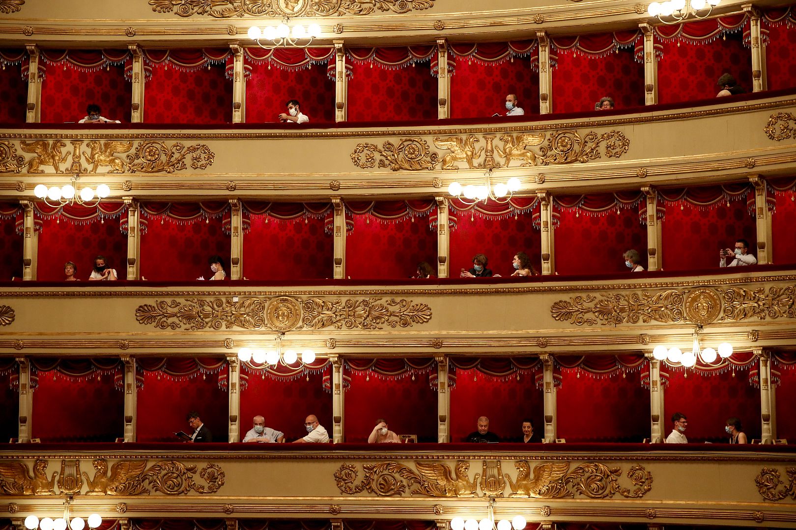 Spectators wearing masks sit prior to a show at the La Scala theater in Milan Italy. 6 July 2020.