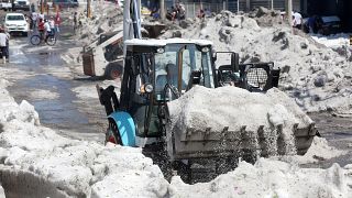 A truck carries ice as it cleans the street after a heavy storm of rain and hail which affected some areas of the city in ​​Guadalajara