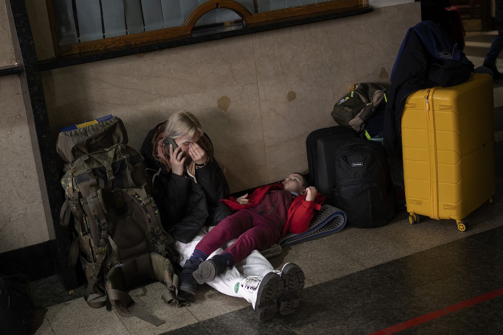 A woman with her daughter waits for a train as they try to leave Kyiv, Ukraine after Russia invaded Ukraine. February 24, 2022