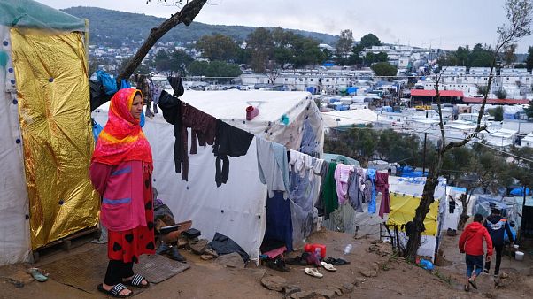 A migrant stands next to their makeshift tent outside the perimeter of the overcrowded Moria refugee camp on Lesbos. A migrant stands next to their makeshift tent outside the perimeter of the overcrowded Moria refugee camp on Lesbos.