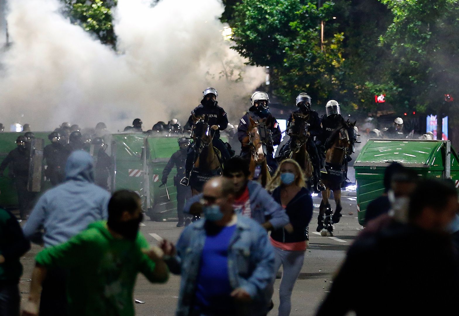Sebian police officers disperse protesters in front of Serbian parliament building in Belgrade, Serbia, July 8, 2020