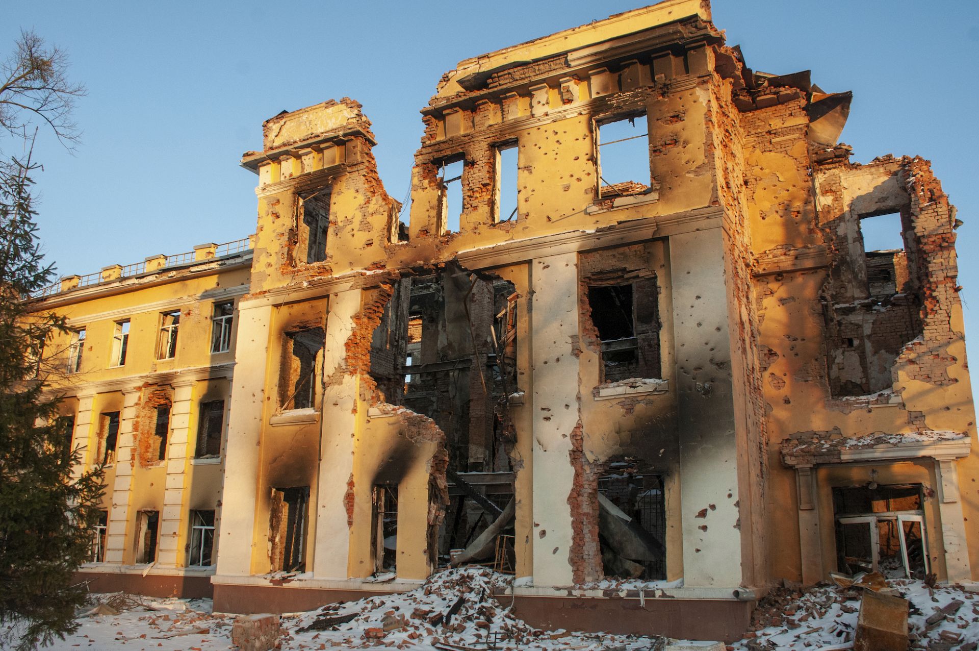 Damaged building in Kharkiv stands lit by sunset after shelling amid the Russian invasion of Ukraine. March 11, 2022.