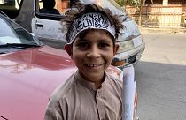 An afghan child wears a bandana emblazoned with black Islamic scripture known as the “Shahada” – the same text written on the Taliban’s flag. Central Kabul, September 2021.