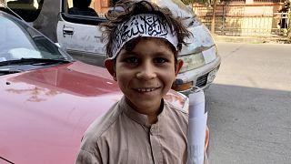 An afghan child wears a bandana emblazoned with black Islamic scripture known as the “Shahada” – the same text written on the Taliban’s flag. Central Kabul, September 2021.