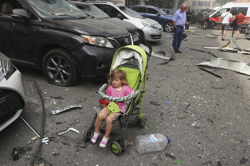 A child waits in a yard after Russia's missile hit the country's main children hospital Okhmadit in Kyiv, July 2024