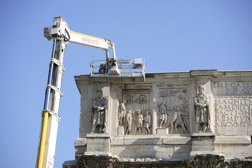 Workers on site with cranes gather up fragments and secure broken areas of the 315 A.D Arch of Constantine, near the Colosseum, in Rome, Wednesday, Sept. 4, 2024, 