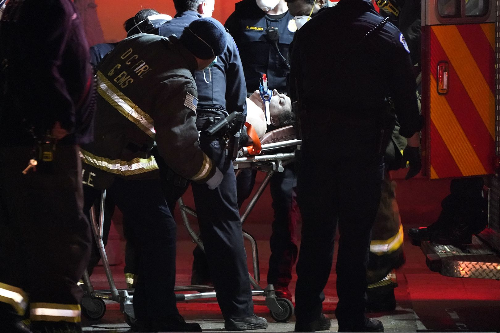 A person on a stretcher is placed in an ambulance outside the U.S. Capitol in Washington, USA. January 6, 2021