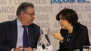 Soraya Saenz de Santamaria talks to Interior Minister Juan Ignacio Zoido