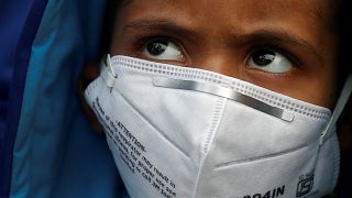 A child wears a face mask for protection from air pollution in Delhi