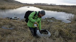 An activist takes radiation readings near Mayak nuclear complex in 2010.