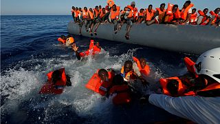 Migrants try to stay afloat during a rescue operation in the Mediterranean