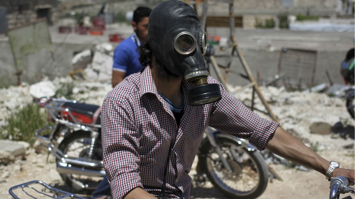 A man wears a gas mask in Idlib, Syria