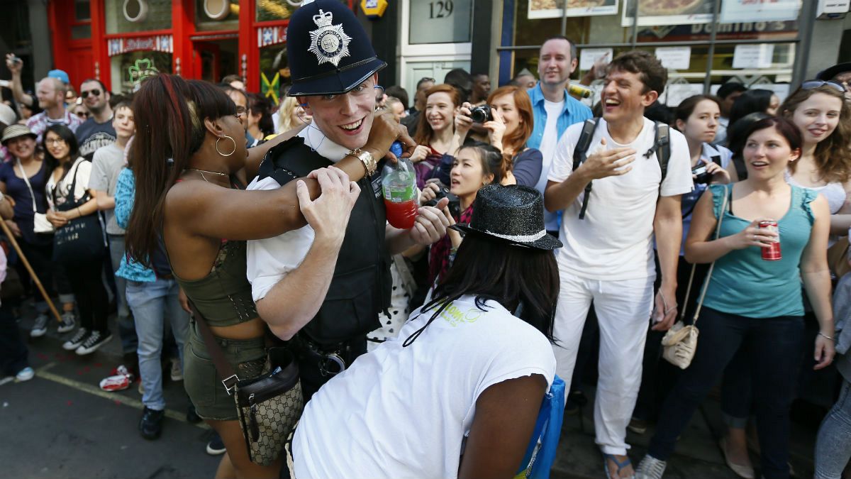 A policeman joins in celebrations at the Notting Hill Carnival in London