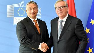Hungary's Prime Minister Viktor Orban (L) is welcomed by European Commissio