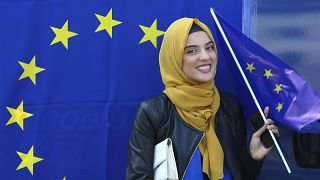 A muslim woman holds an European flag during a pro-EU demonstration