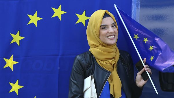 A muslim woman holds an European flag during a pro-EU demonstration A muslim woman holds an European flag during a pro-EU demonstration