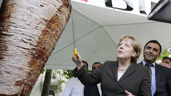 German Chancellor Angela Merkel cuts a piece from a kebab meat loaf German Chancellor Angela Merkel cuts a piece from a kebab meat loaf