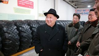 North Korea's leader Kim Jong Un inspects tyres at a factory 