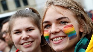 A lesbian couple poses for a picture as people celebrate Germany's parliame