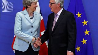 Theresa May is greeted by European Commission President Jean-Claude Juncker