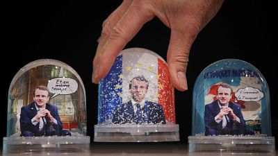 Snowglobes depicting French President Emmanuel Macron, made by Bruot compan