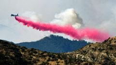 An aircraft drops fire retardant on a wildfire in Filmore, California 