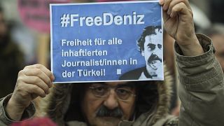 A protester demands the release of Deniz Yucel during a Hamburg rally