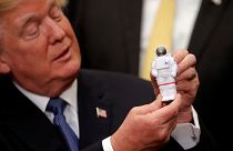 President Trump holding an astronaut toy at the signing ceremony, Dec. 11