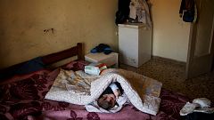 The baby daughter of Kostas and Olga Argyros rests in her parents' bed at t
