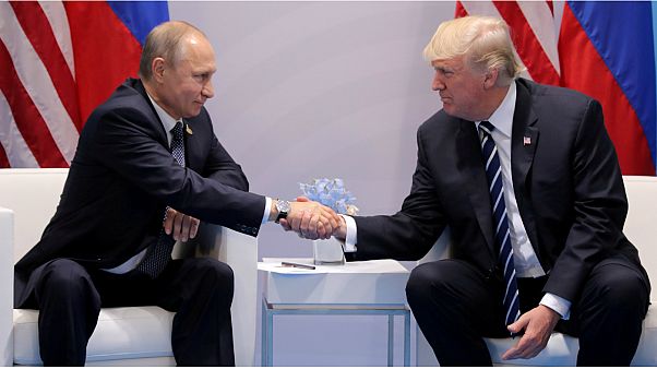 U.S. President Trump shakes hands with Russia's President Putin U.S. President Trump shakes hands with Russia's President Putin