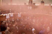 Albania's opposition lawmakers throw smoke bombs inside the Parliament 