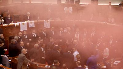 Albania's opposition lawmakers throw smoke bombs inside the Parliament duri